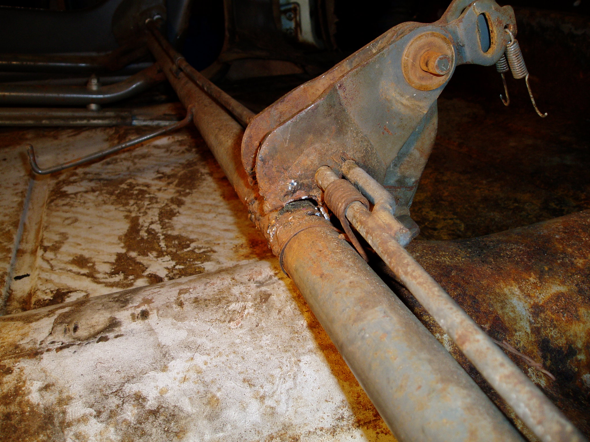 A view from the driver's side. Both of the hingers should be welded to the seat frame tube but have torn loose and moved.