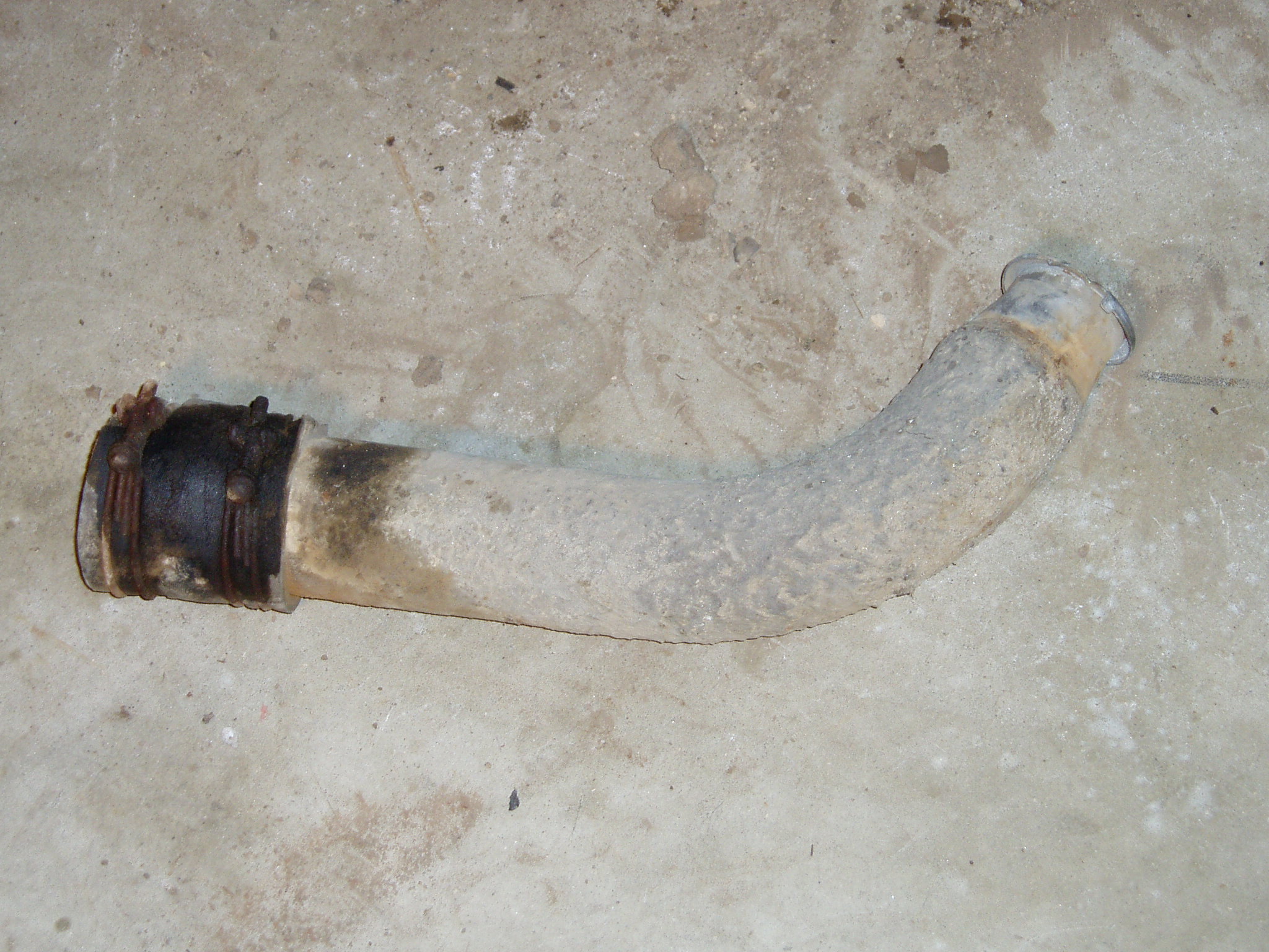 Steel tube / hose connecting filler cap to tank. The poor condition of the rubber explains why there was always gas on the groun
