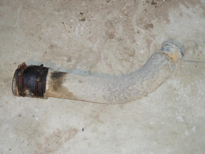 Steel tube / hose connecting filler cap to tank. The poor condition of the rubber explains why there was always gas on the groun