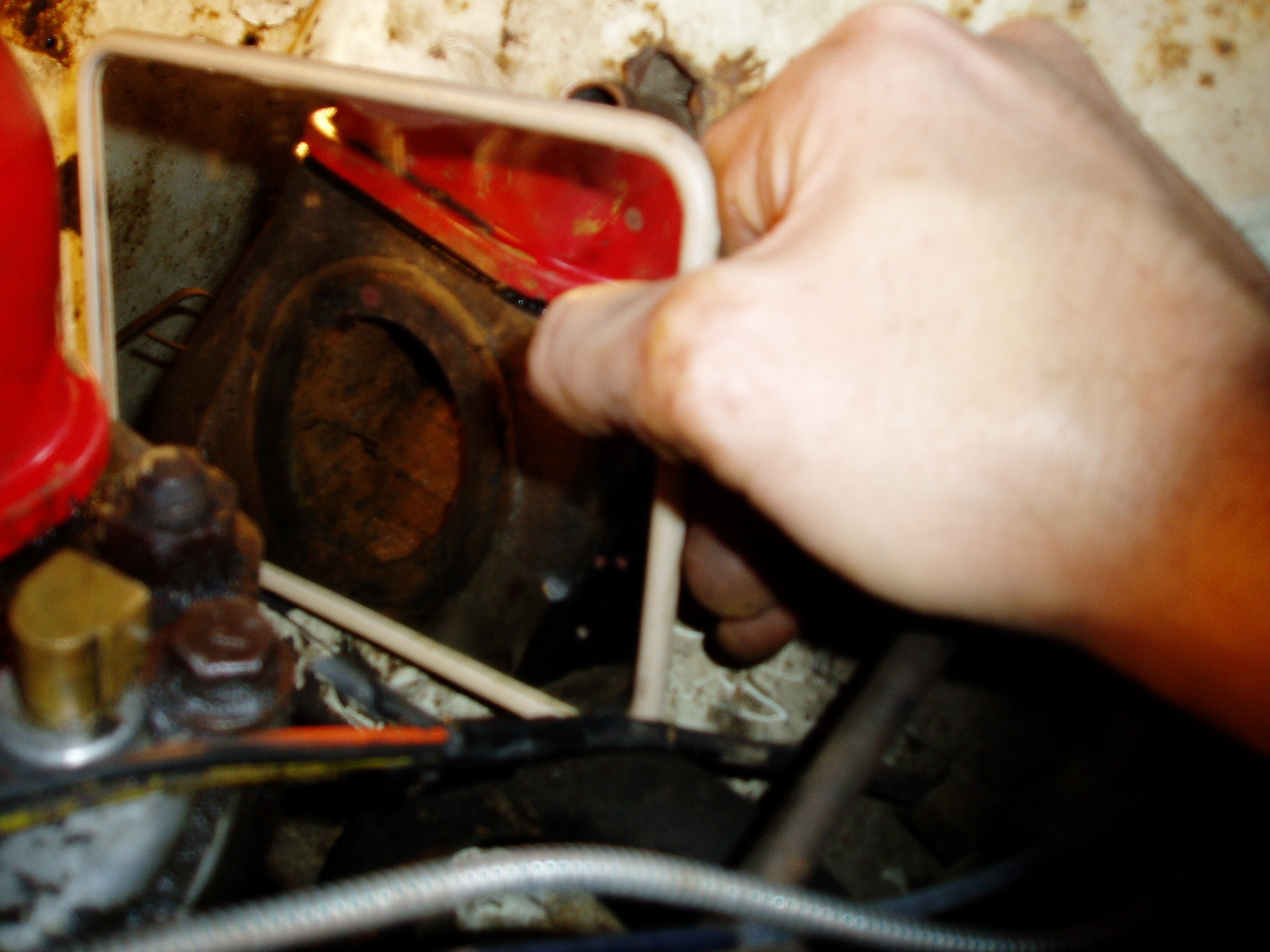 The crud-filled hole. I used a magnet tool to pull out the collected metal chips.