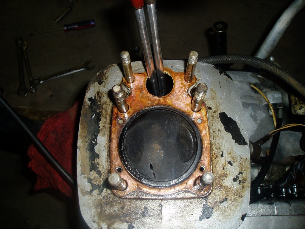 Big f**ing hole in the piston.