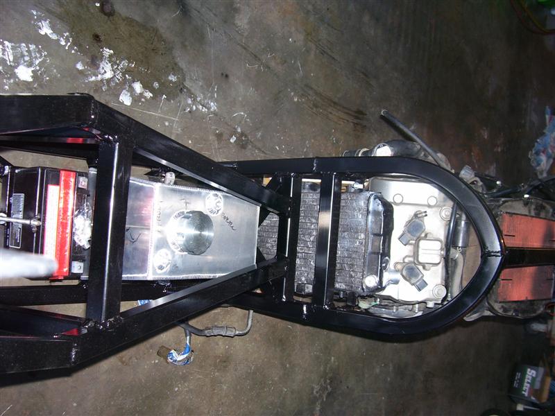 View from above forks looking down on the bike. Battery is in front of the fuel tank.