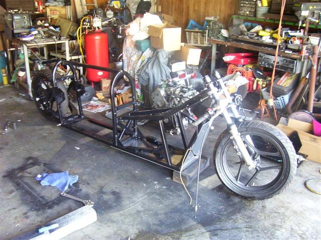 Forks & swing arm mounted on the frame.