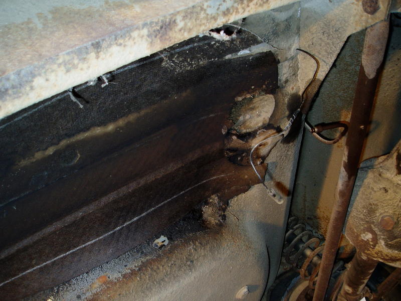 Underside where gas tank hung. There was a STUPENDOUS amount of dirt around the filler tube. 50 years of mud kicked up by the re