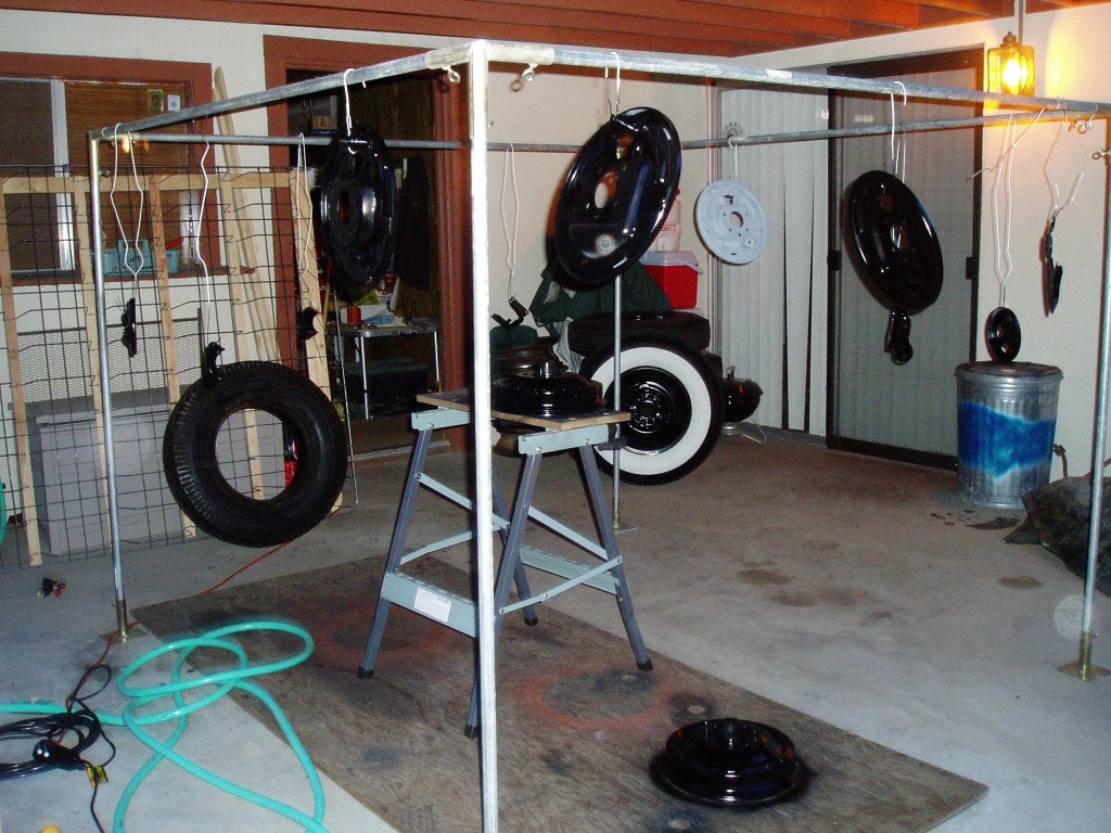 2/22/06. Front and rear-end parts getting paint on the back porch. The pile of tires in the background are mounted on the newly 