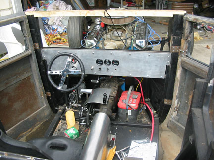 The dash. The tach is in the middle, thru the steering wheel. I made a cover for the shift rods. The battery will be mounted the